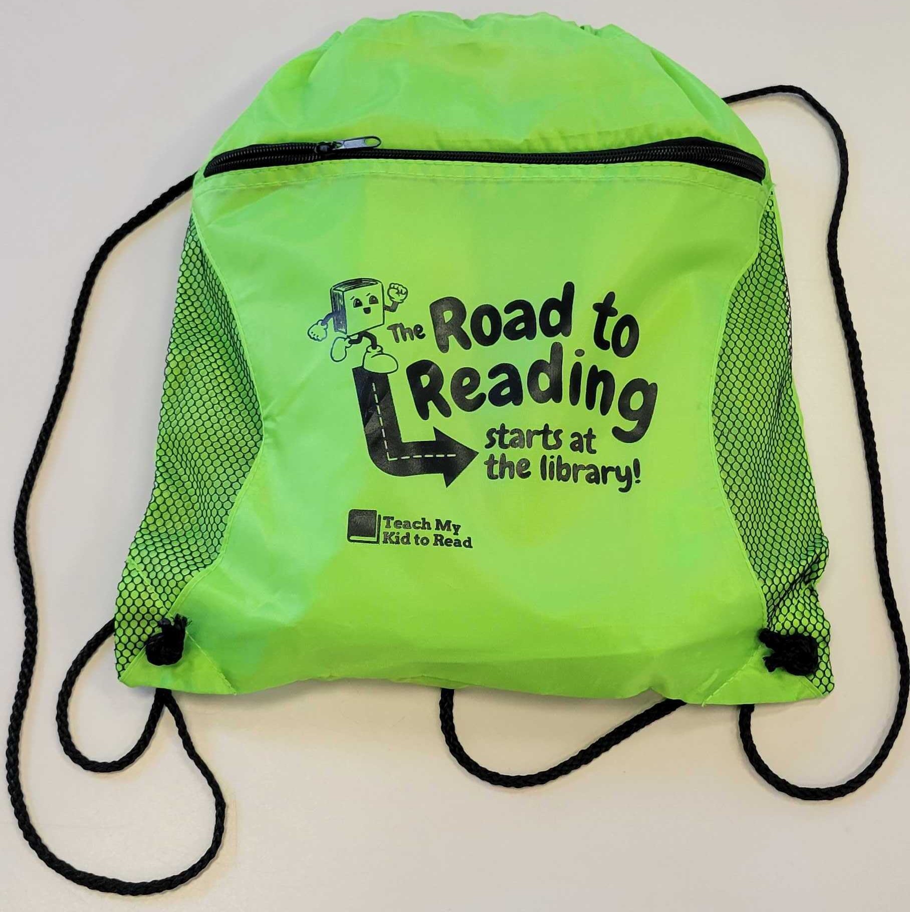 Bright green backpack with the words 'The Road to Reading Starts at the Library' from Teach My Kids to Read 